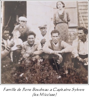 The family of René Boudreau seated outside a house