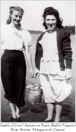 Sophie (Girroir) Samson and Rosie (Babin) Forgeron standing in the water with a bucket of clams